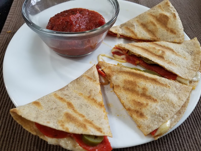 Image of pizza quesadillas on a plate with pizza sauce