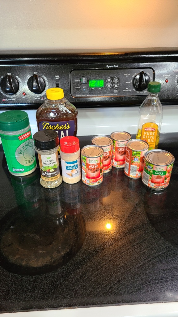 Ingredients for pizza sauce on a stovetop