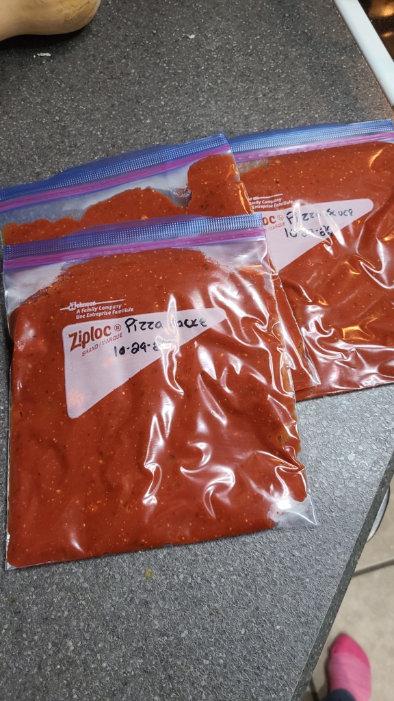 3 quart-sized freezer bags filled with pizza sauce