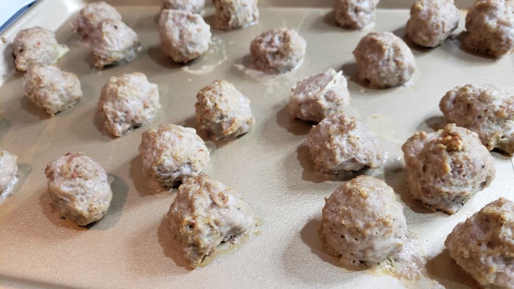 Cooked meatballs on a baking sheet