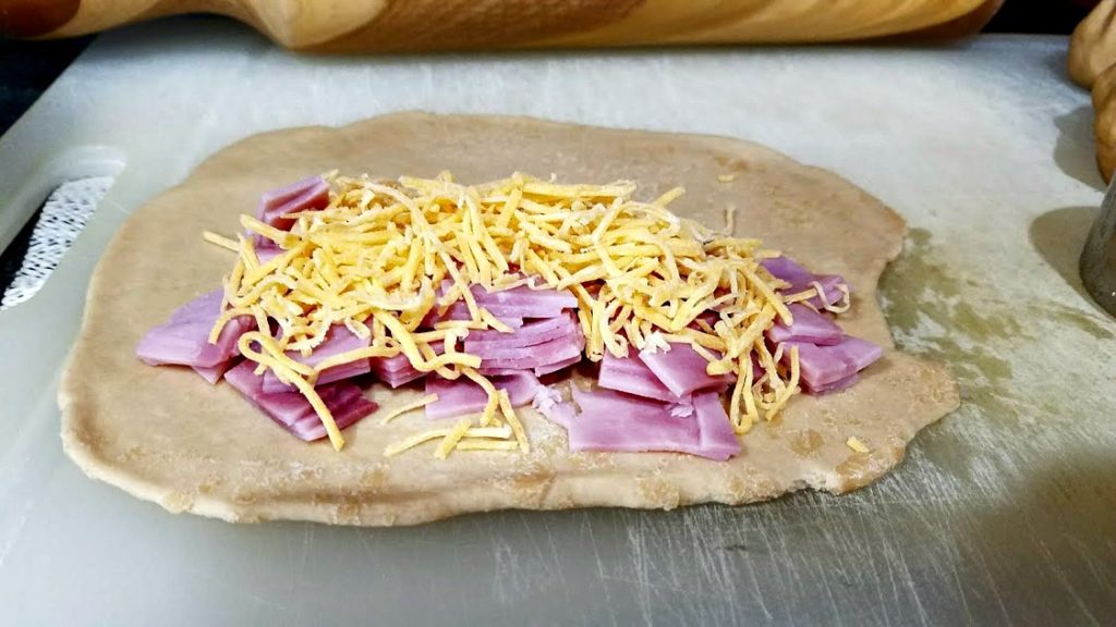 Image of opened up ham and cheese pocket