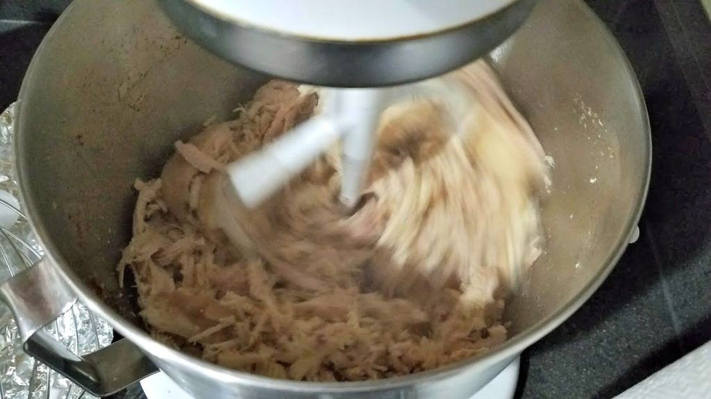Image of chicken being shredded in a Kitchen Aid mixer