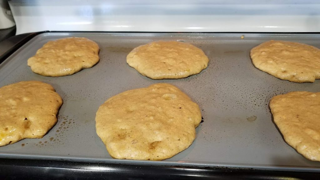 Pancake batter cooking on a griddle