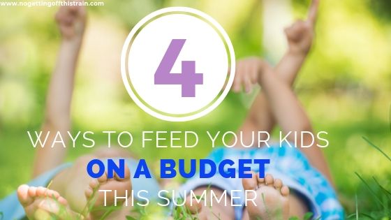 Image of children laying in the grass with the title "4 Ways to Feed Your Kids on a Budget This Summer"