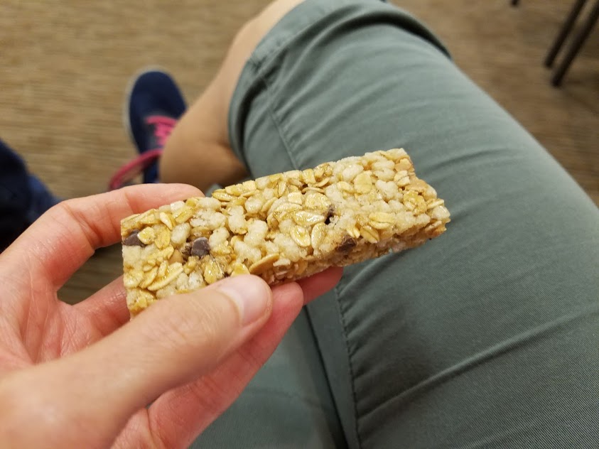 Image of a hand holding a granola bar