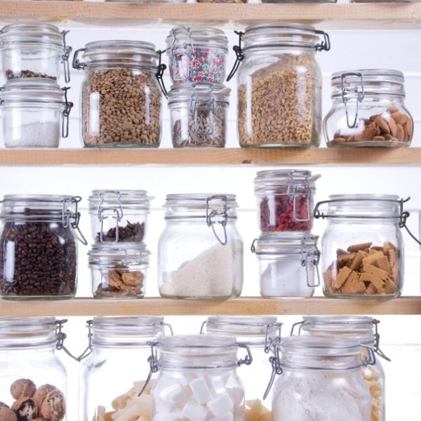 A pantry cupboard with jars of bulk foods