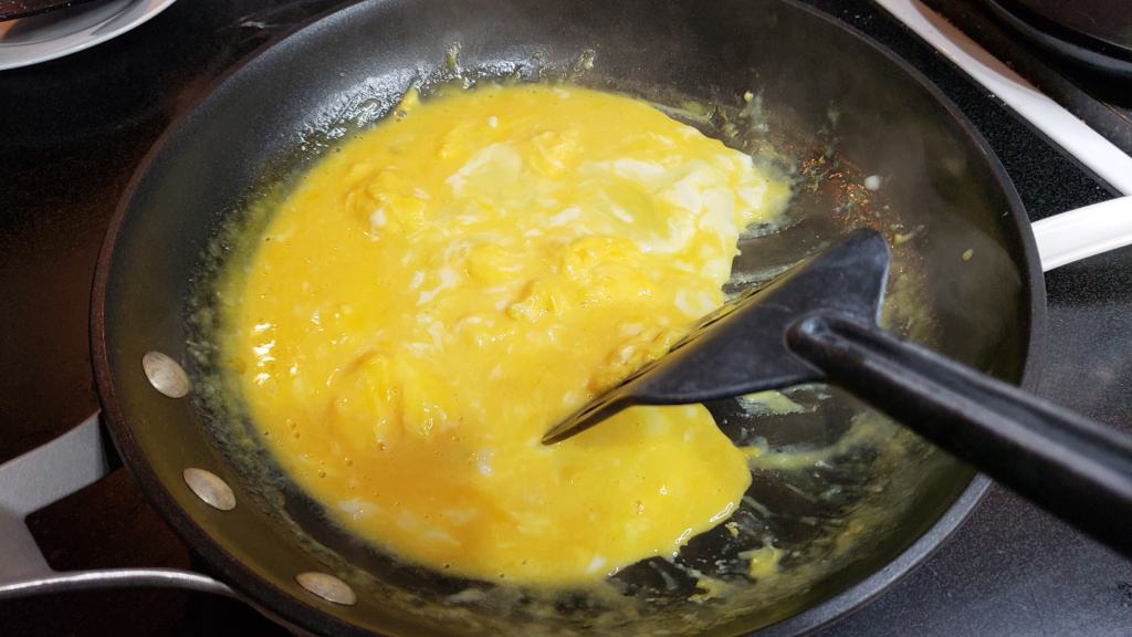 Eggs scrambling in a pan