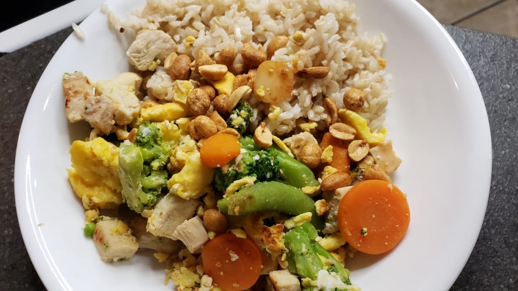 Chicken stir fry in a bowl with rice