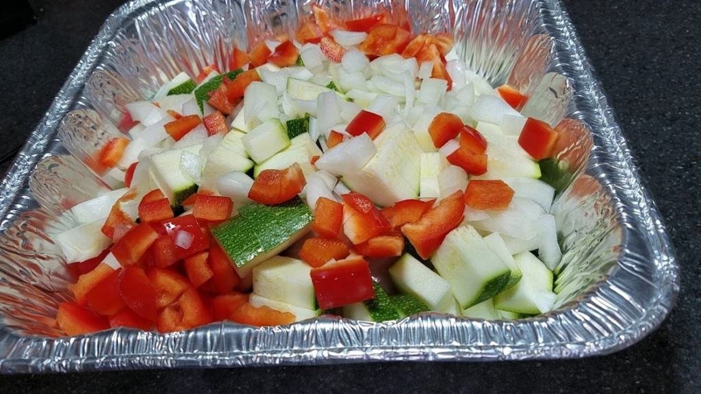 Image of chicken and vegetables in a foil pan