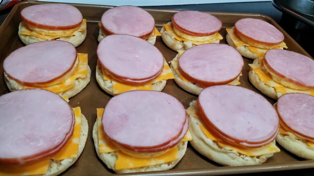 Image of English muffins with cheese, egg, and Canadian bacon