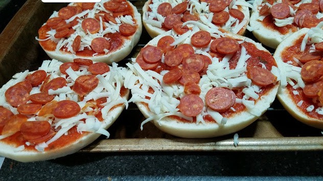 Image of pizza bagels on a cookie sheet