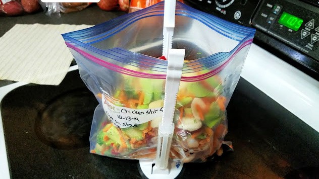 Image of chicken stir fry ingredients being loaded into a freezer bag