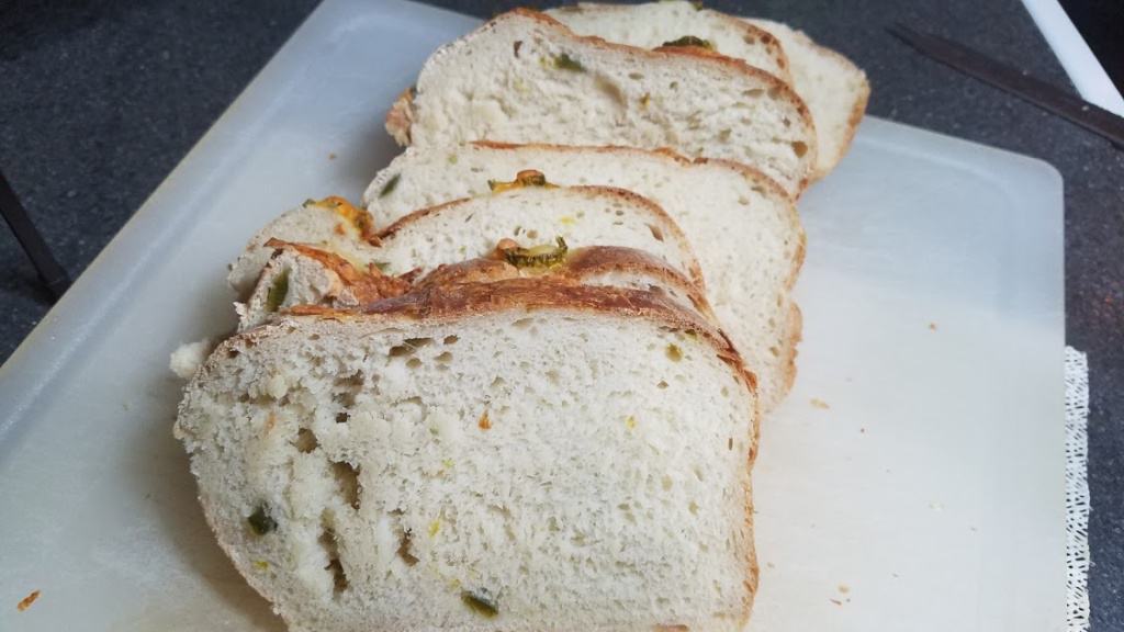 Image of a sliced loaf of Jalapeno Cheese Bread on a cutting board