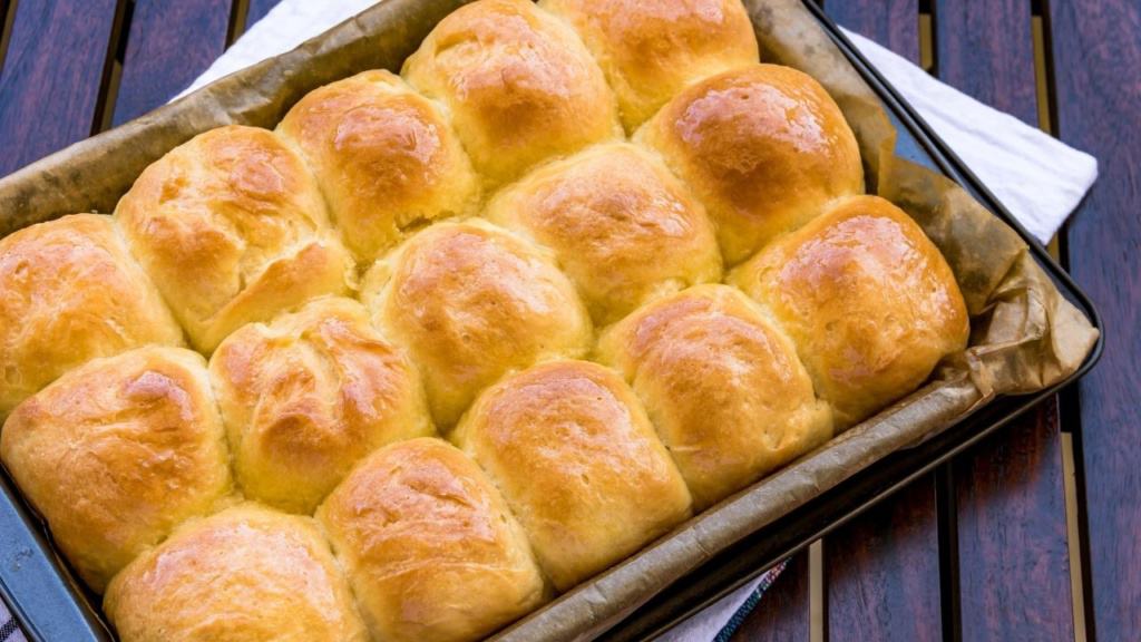 A baking dish filled with baked dinner rolls