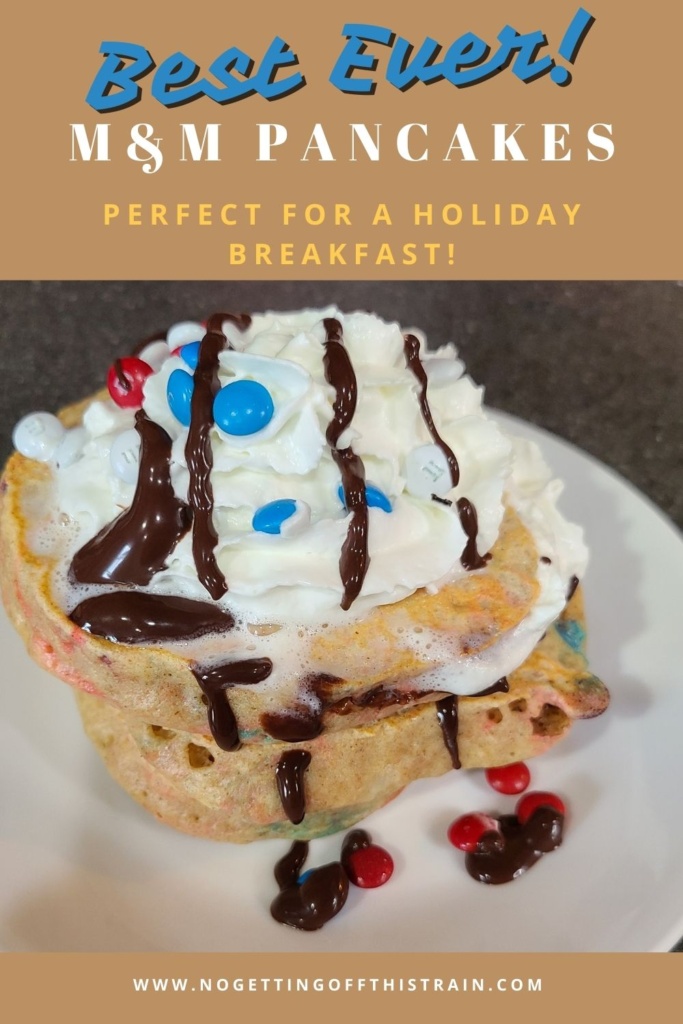 A stack of pancakes on a plate with the title "Best ever m&m pancakes- perfect for a holiday breakfast!
"
