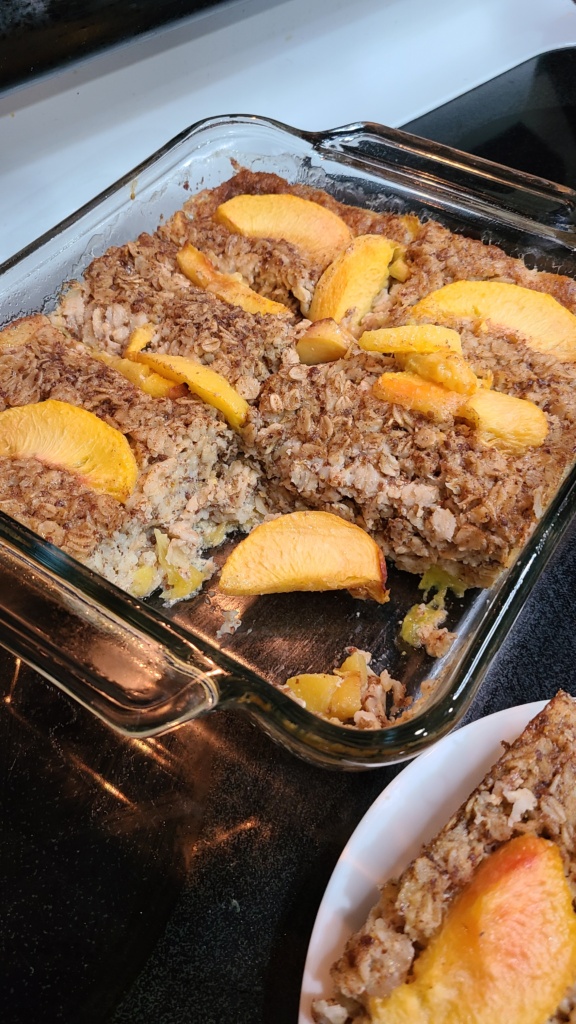 Cooked peach baked oatmeal in a casserole dish