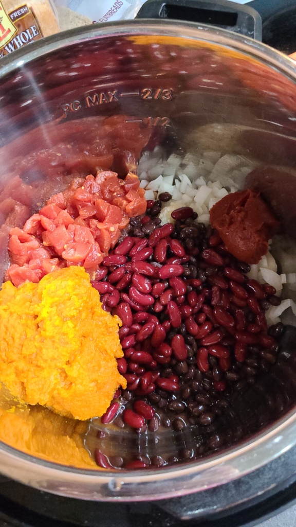 Ingredients for pumpkin chili in a slow cooker