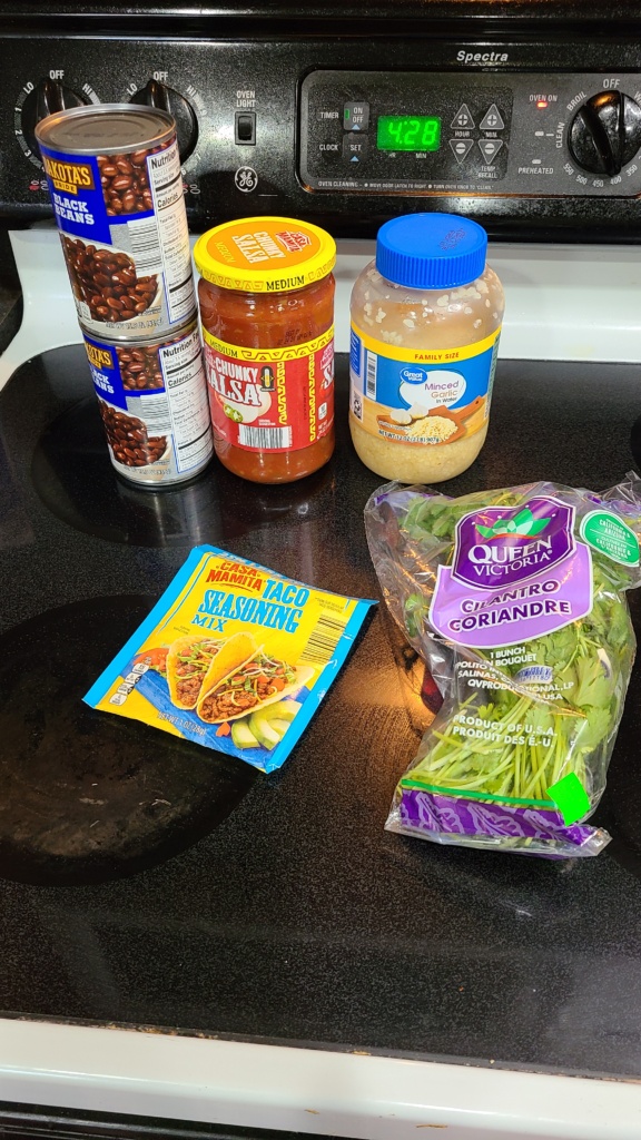 Ingredients for black bean soup on a stovetop
