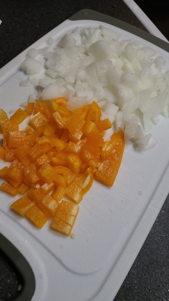 Chopped onion and pepper on a cutting board