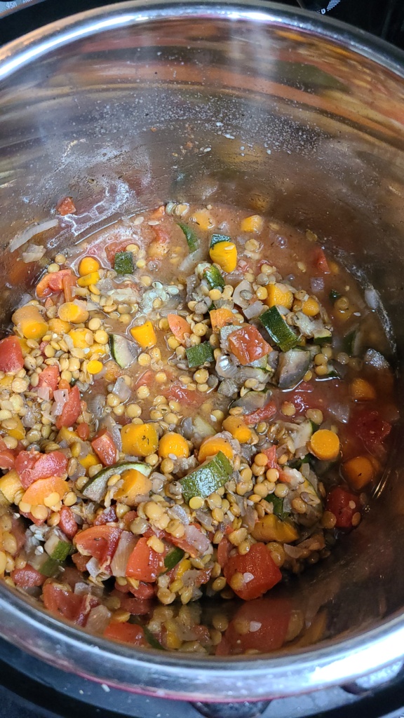 Cooked lentils and vegetables inside a slow cooker
