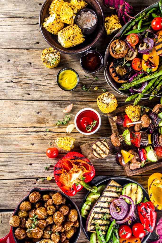 Various cooked vegetables in bowls on a wooden table