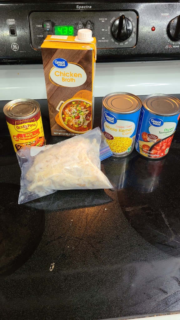 Ingredients for chicken tortilla soup on a stovetop