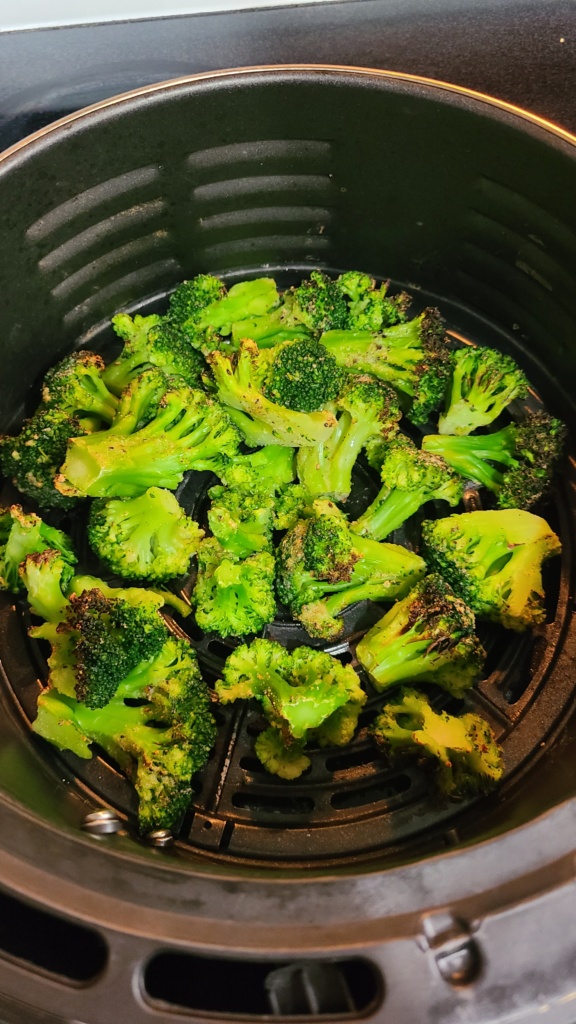 Air fryer basket with roasted broccoli
