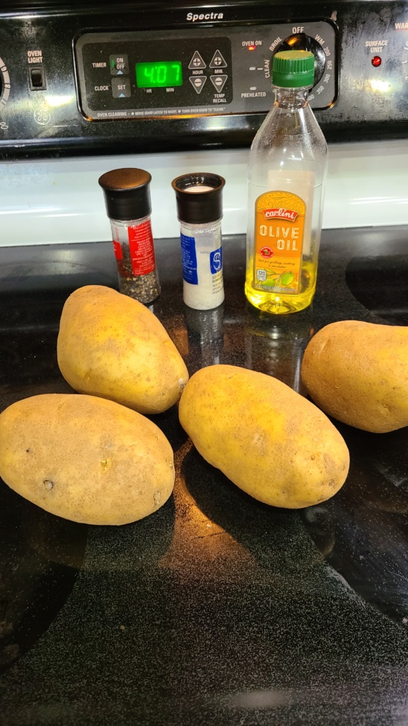 Potatoes, olive oil, salt, and pepper on a stovetop