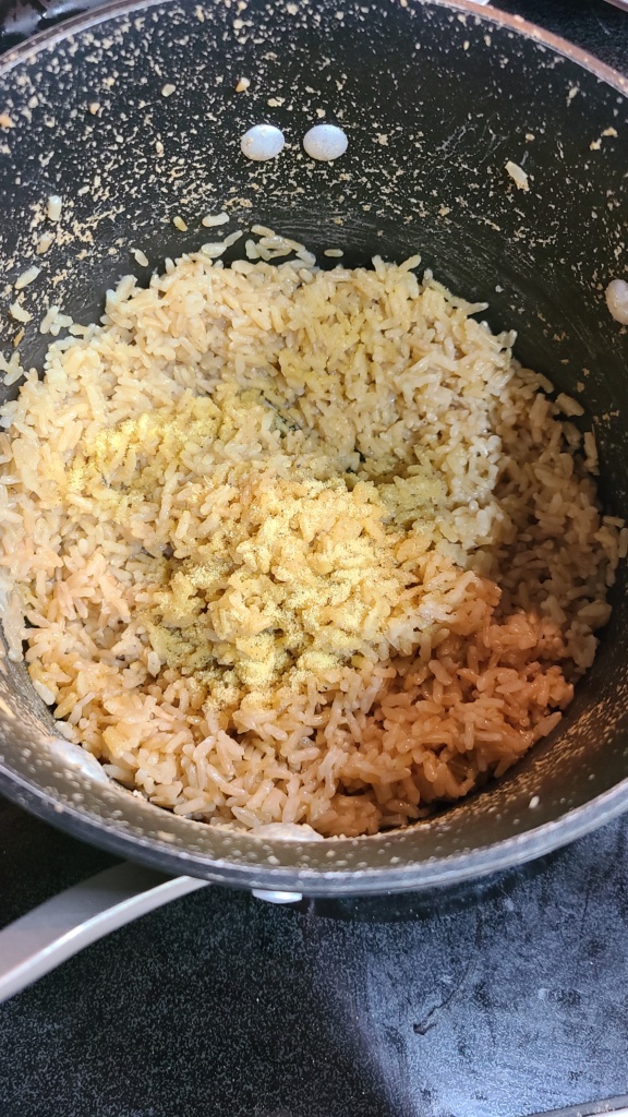 A small pot filled with cooked rice