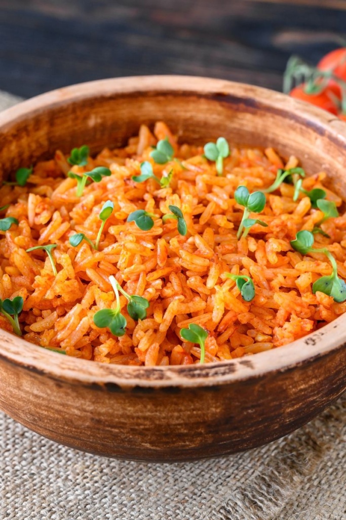 A wooden bowl filled with Spanish rice