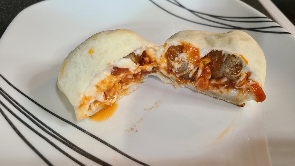 A plate with a meatball calzone