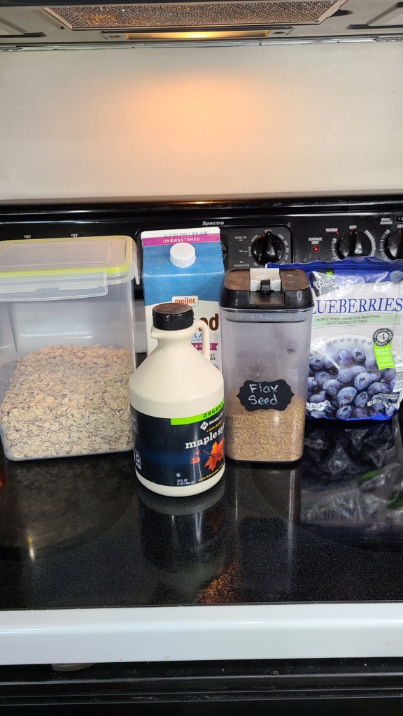Ingredients for blueberry oatmeal smoothie sitting on a stovetop