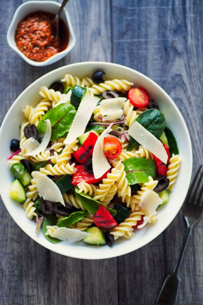 A bowl of colorful pasta salad with lots of vegetables