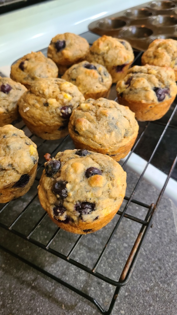 Banana blueberry muffins on a wire cooling rack