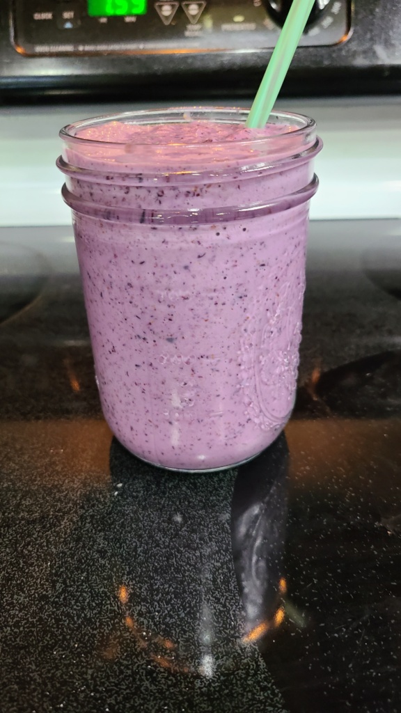 Blueberry protein shake in a Mason jar