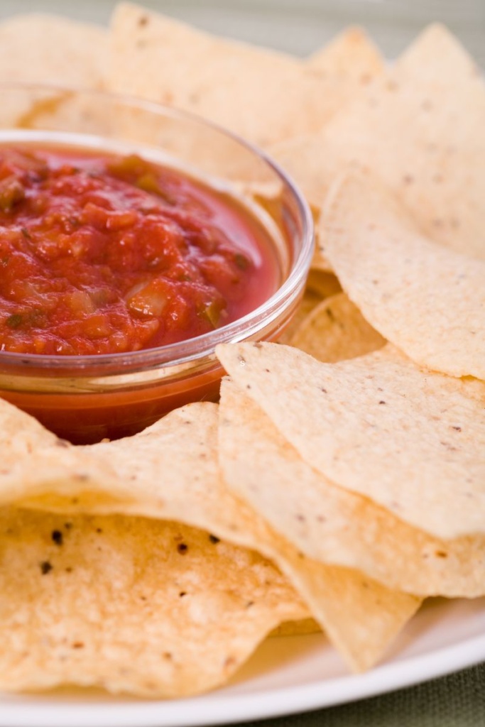 Tortilla chips next to a bowl of salsa