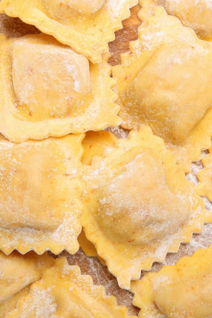 Floured ravioli on a cutting board