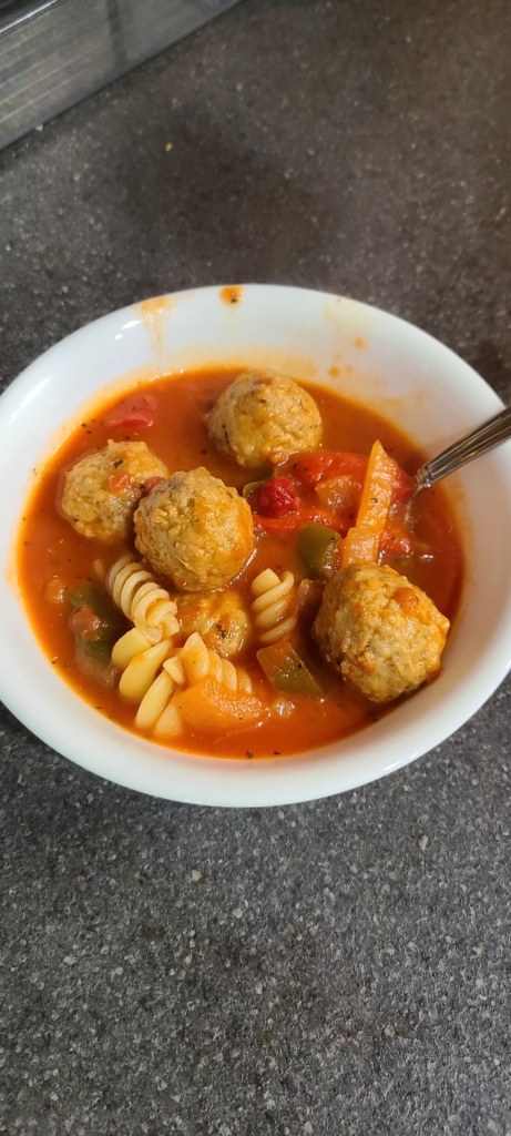 A bowl filled with meatball soup