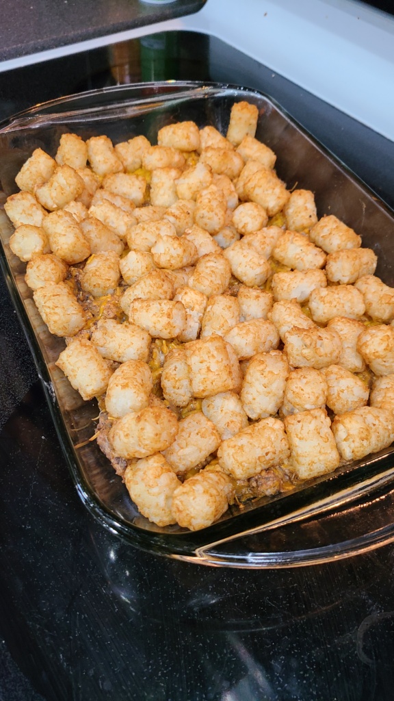 A 9x13 casserole dish filled with cooked tater tot casserole