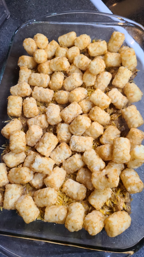 A 9x13 casserole dish with unbaked tater tot casserole