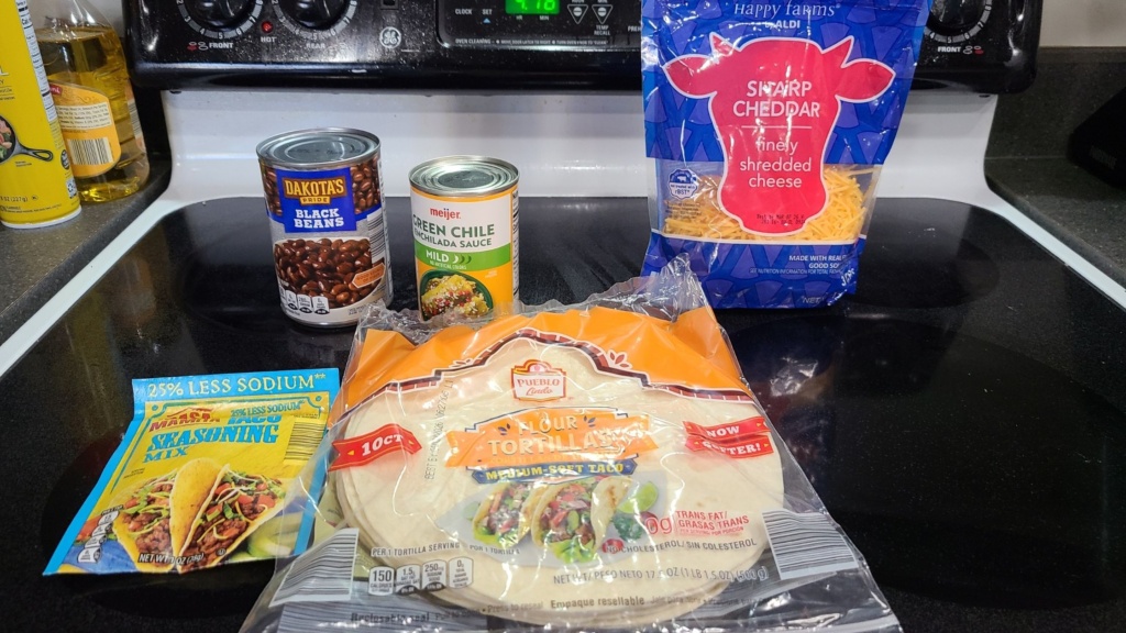 Ingredients for black bean enchiladas, on a stovetop