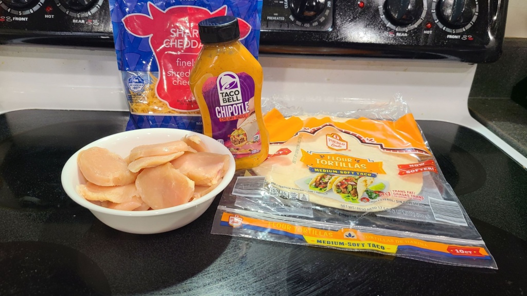 Ingredients for chipotle chicken quesadillas, on a stovetop