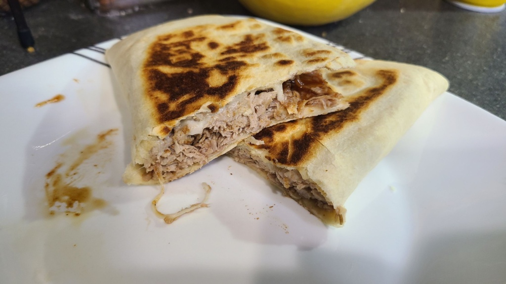 A cooked pulled pork quesadilla on a plate