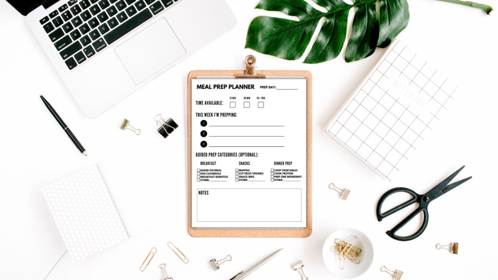 A clipboard that holds a meal prep planner