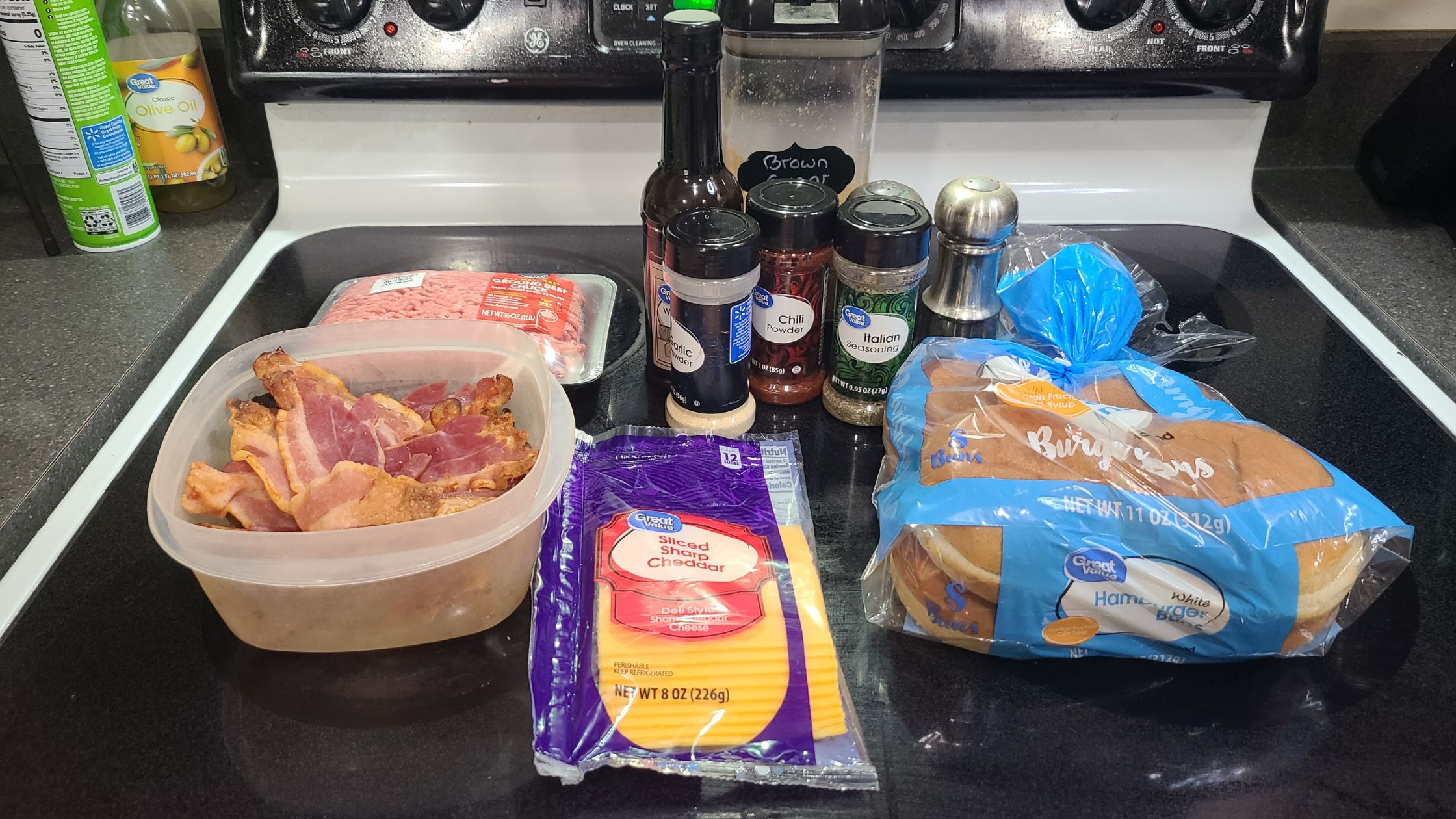 Ingredients for BBQ bacon burgers, on a stovetop
