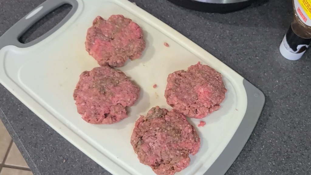 Formed burger patties on a cutting board