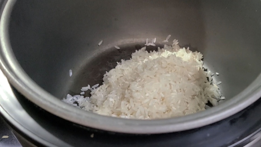 Dried rice in the bottom of a rice cooker