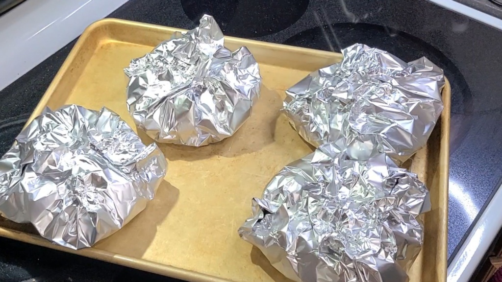 Kielbasa ingredients wrapped in 4 pieces of aluminum foil