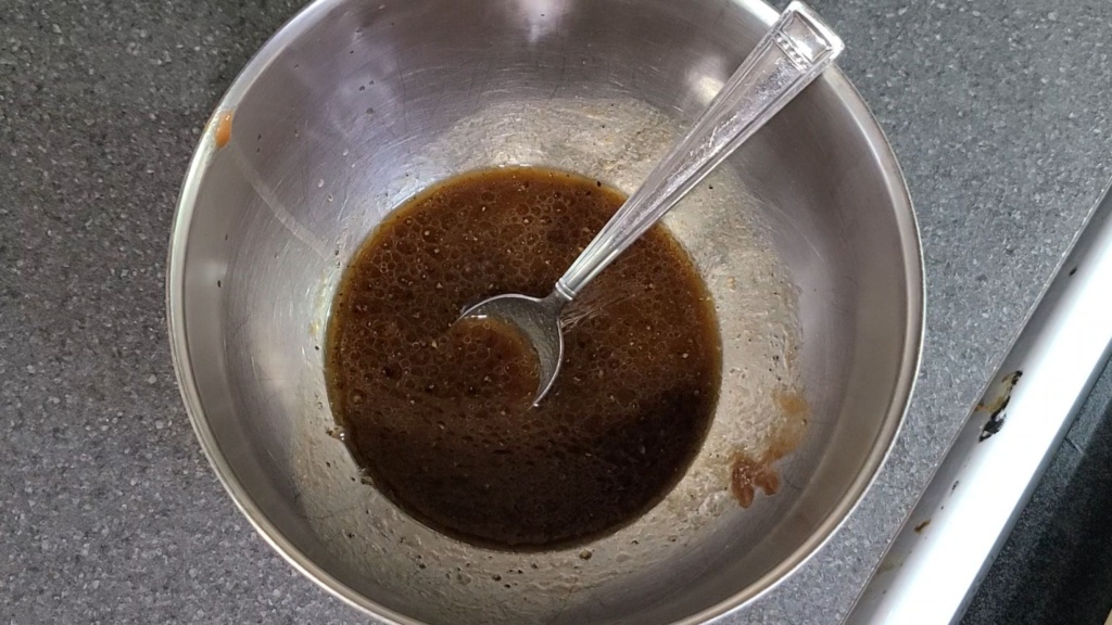 A bowl filled with ingredients for the sauce