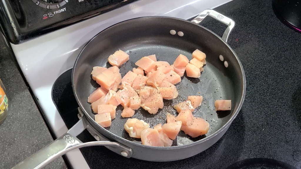 Cubed chicken cooking on a skillet